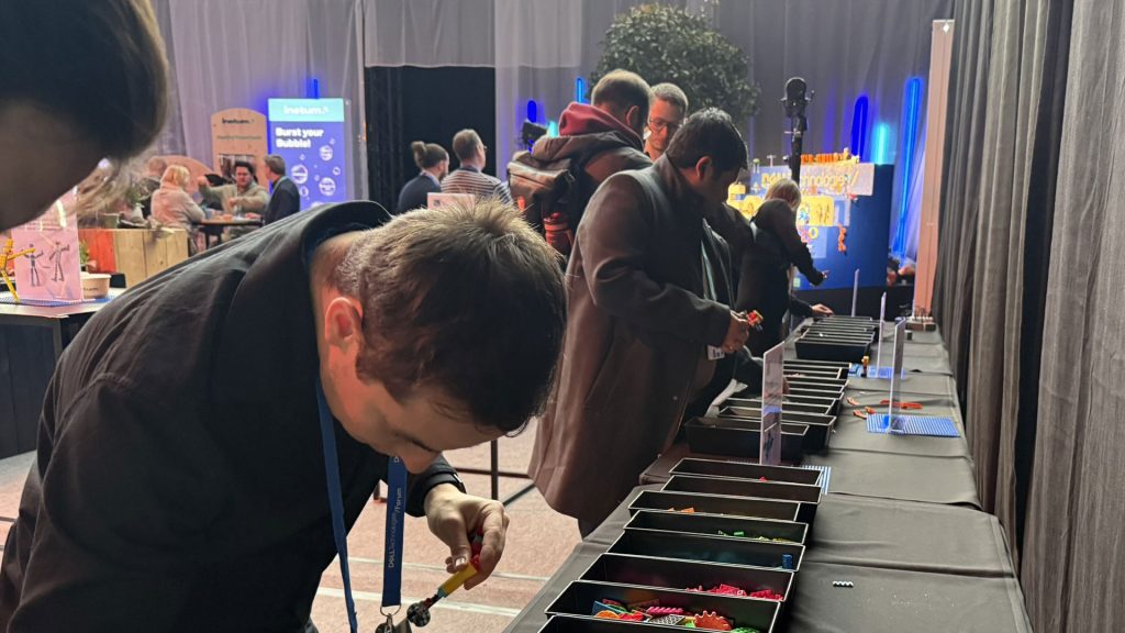 Participants building something on the DELL Technologies/ Forum artwork with THE POWER OF BRICKS